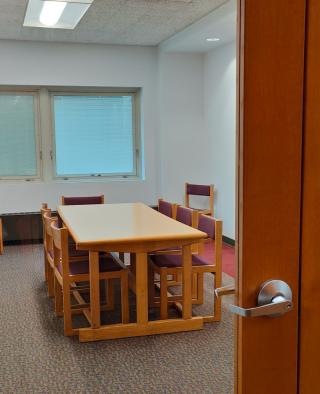 Photo of one of the meeting rooms showing a table and chairs.